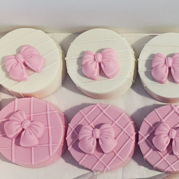 Dipped Oreos in white and pink with sugar bows