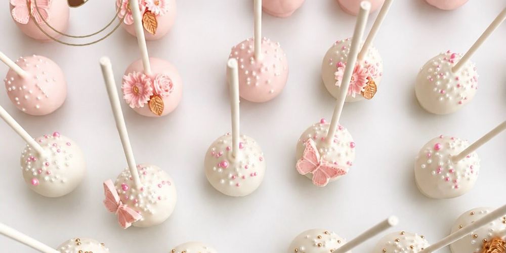 Pink and white cake pops with flowers and butterflies