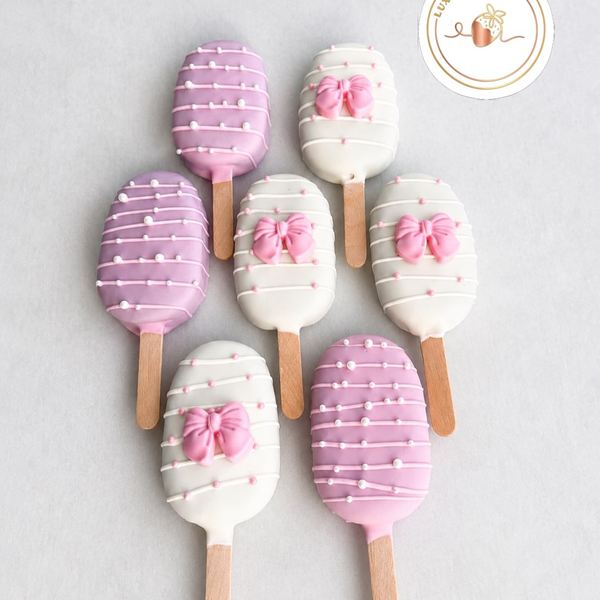 Pink and white cakesicles with bows