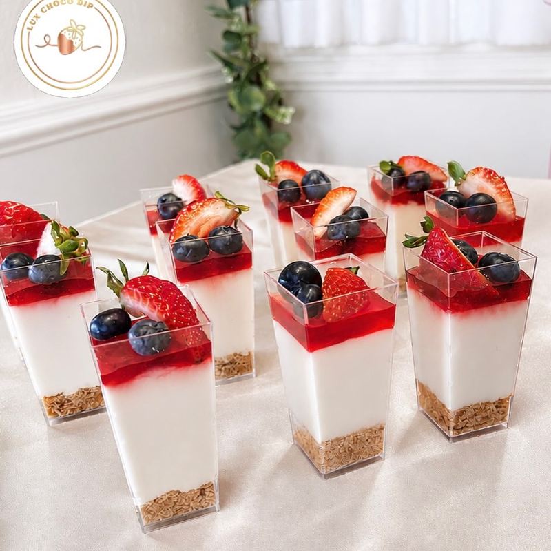Mini cheesecake cups with strawberries and blueberries